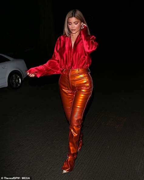Kylie Jenner Rocks Red Silk Blouse And Shiny Orange Pants For Mask Free