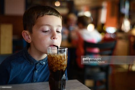 Boy Drinking Sugary Drink High Res Stock Photo Getty Images