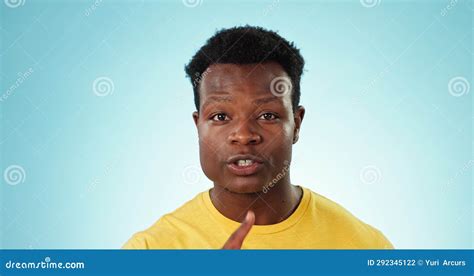 Black Man Face And Secret For Gossip Whisper Or Privacy With Finger On Lips Isolated On A Blue