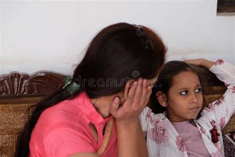 Closeup Shot Of An Indian Woman Talking To Her Daughter While Sitting On A Couch Stock Image