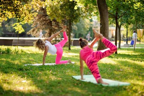 Group Of Women Doing Yoga Exercises On The Grass In A Park Legs Shot Stock Image Image Of