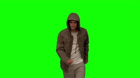 Man With A Coat Walking Toward Camera On Green Screen In Slow Motion
