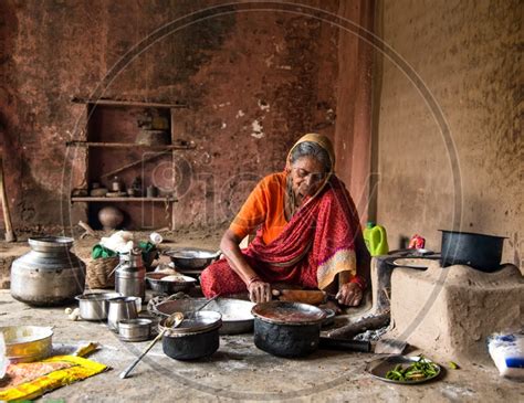 Image Of An Indian Old Woman Making Or Cooking Food In An Ancient Or