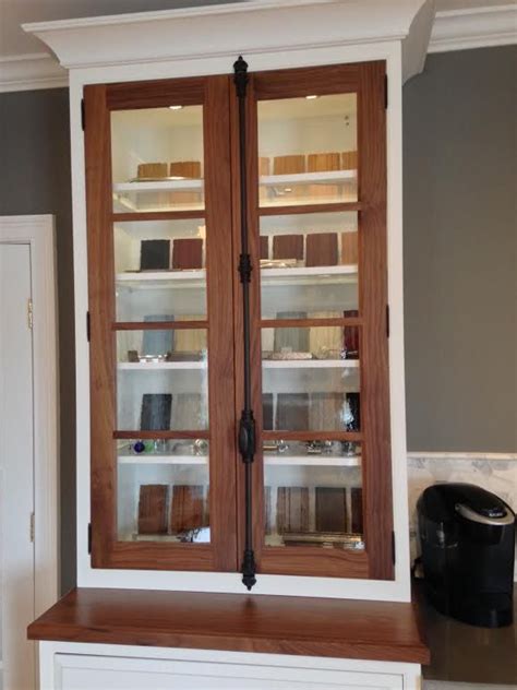 One cabinet with cremone bolt hardware in an antique pewter finish opens to reveal shelved storage space for towels and supplies, while a matching decorative wood backsplash rounds out the set. Walnut doors and countertop with cremone bolt. | Walnut ...