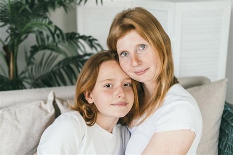 Premium Photo Mom And Daughter With Red Hair Mom And Daughter Teen Hugging At Home On The Couch