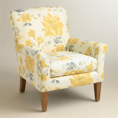 It is mounted on wooden legs. Yellow Fleurs Estelle Chair | World Market