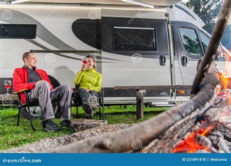 Couple Drinking Wine In Front Of Their Rv Camper Van Stock Photo