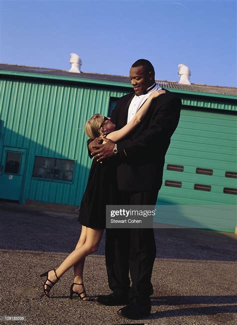 Tall Man And Short Woman Outside Of Warehouse Photo Getty Images