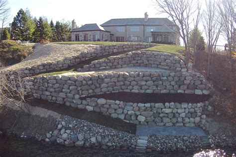 Nec provides full landscaping services such as landscape design and installation, specializing in retaining walls. Naturalistic — Stonewall Inc. Boulder Landscaping