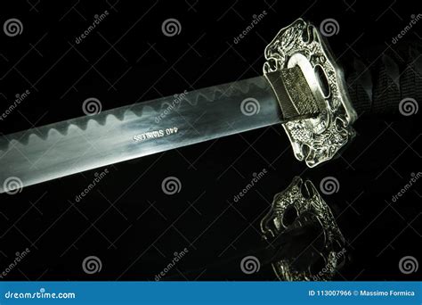 Katana Sword On A Black Background And Reflective Table Stock Photo