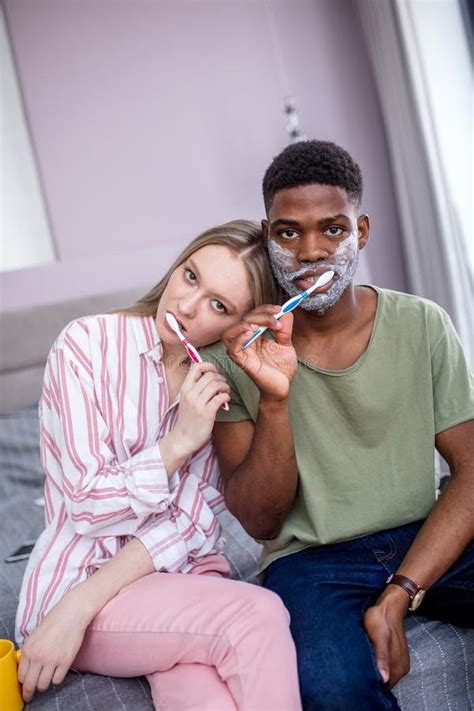 Couple Washing Teeth In Morning Dental Hygiene Is Important Stock
