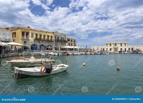 Several Boats And A Lively Crowd At The Restaurants In The Harbor Of