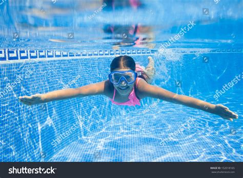 Cute Girl Swimming In Pool Underwater And Smiling Stock Photo 152018165