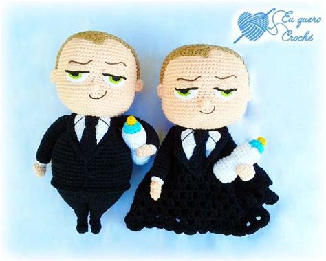 Two Crocheted Dolls Are Dressed In Black And One Is Holding An Ice