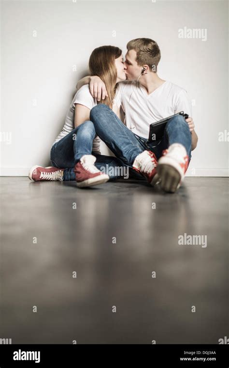 teenager paar sitzt am boden küssen stockfotografie alamy