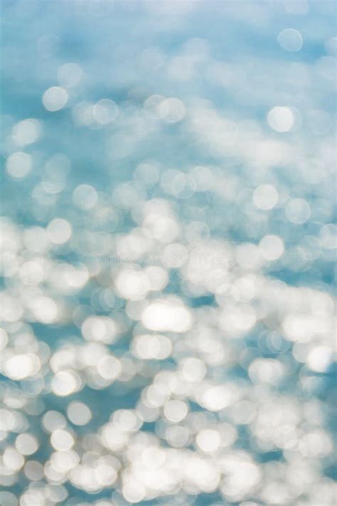 Abstract Shining Sunlight Bokeh On Blue Sea Water Texture Background