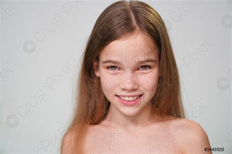 Preteen Girl With Blond Hair And Freckles