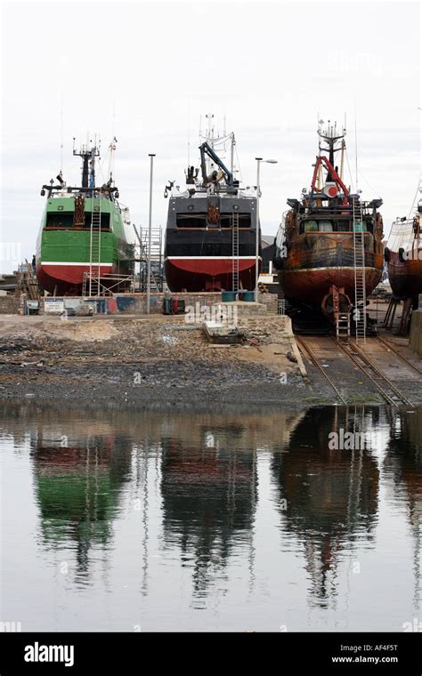 Fishing Boats Being Repaired Out Of The Water At Macduff Harbour