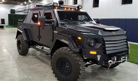 An Armored Vehicle Parked In A Building With Lights On Its Roof And