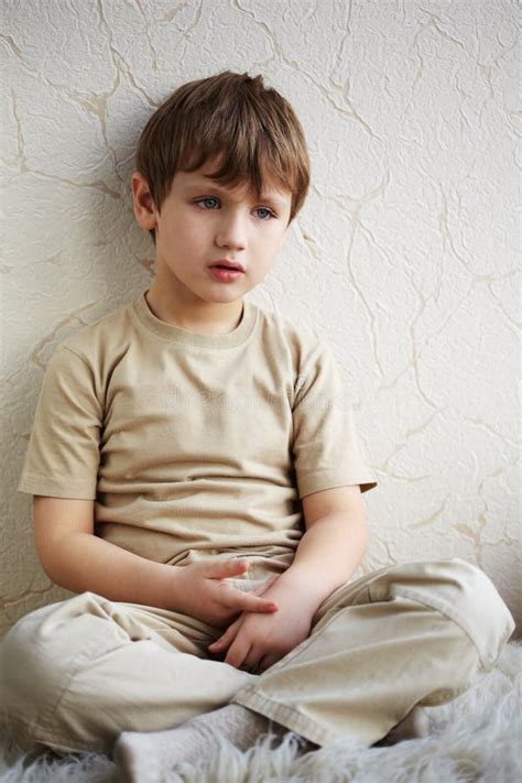 Little Boy Sits Alone On Fleecy White Rug Stock Photo Image Of Knees