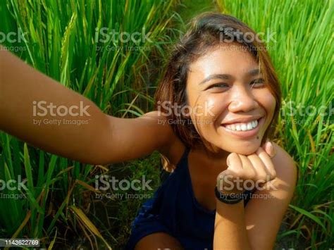 Young Happy And Exotic Islander Asian Girl From Indonesia Taking Selfie