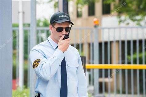 Security Guard Talking On Walkie Talkie — Stock Photo © Andreypopov