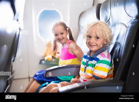 Child In Airplane Kids Sit In Air Plane Window Seat Flight