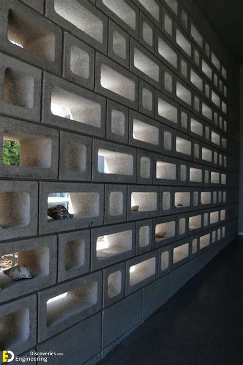 A Wall Made Out Of Concrete Blocks With Lights On Each Side And Small