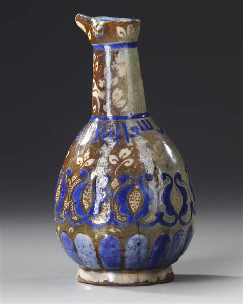 a small kashan lustre pottery jug persia 13th century