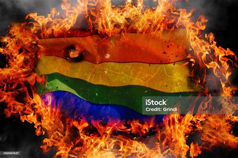 concept of lgbt tolerance burning rainbow flag of lgbt on fire flames background blackened