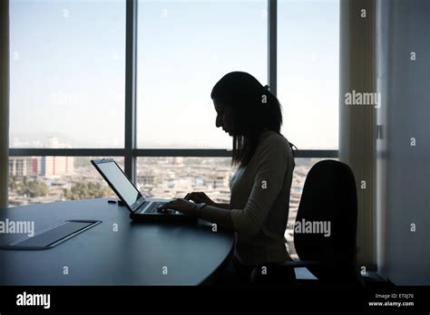 A Corporate Women Executive Working On Her Laptop At Her Office In