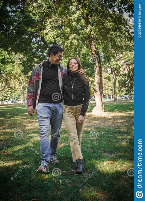 Cheerful And Romantic Couple In Love Walk Together In Nature Stock