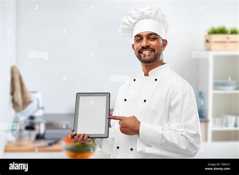 Cooking Technology And People Concept Happy Male Indian Chef In Toque With Tablet Computer