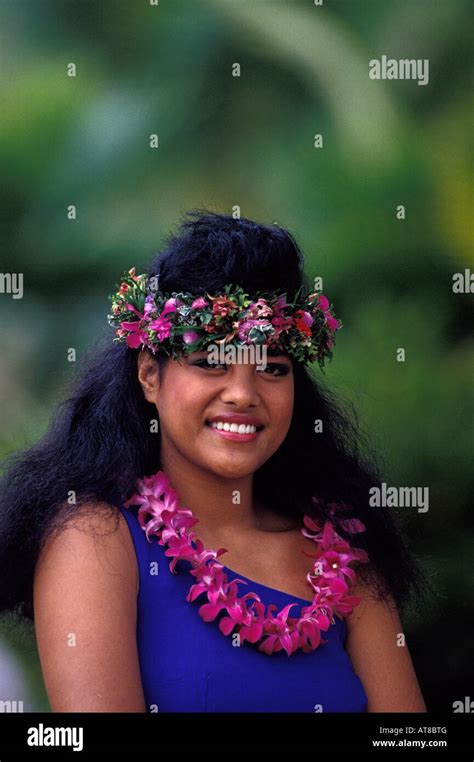 A Beautiful Young Samoan Woman Wearing A Pink Lei And Haku Lei Smiles