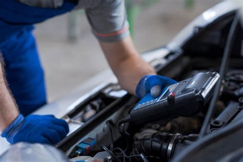 Premium Photo Mechanic Using A Battery Tester