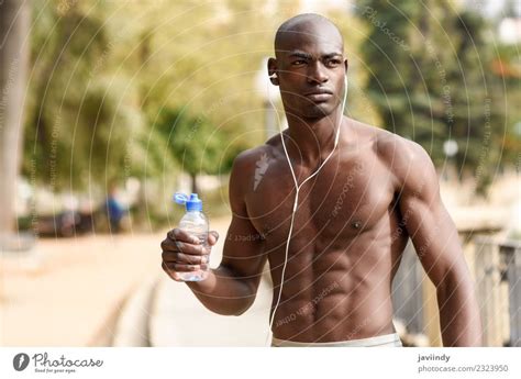Fit Shirtless Young Black Man Drinking Water After Running A Royalty