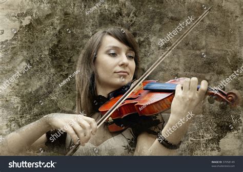 Beautiful Female Violinist Playing Violin On The Grunge Background
