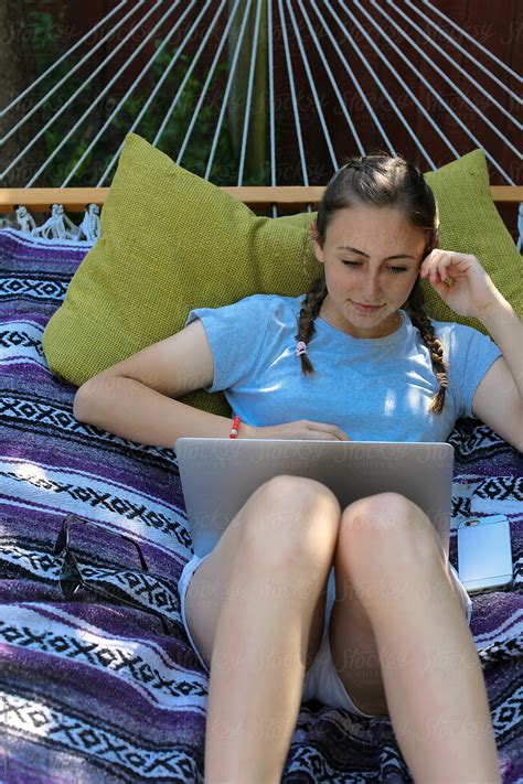 Teenage Girl On A Hammock Looking At Her Laptop By Stocksy Contributor Carolyn Lagattuta