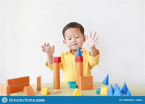 Cheerful Asian Little Baby Boy Playing A Colorful Wood Block Toy On