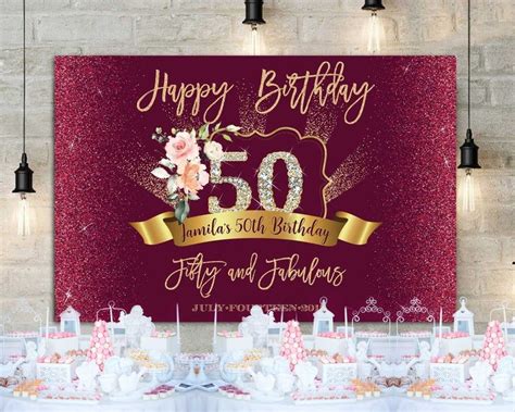 A 50th Birthday Banner With Flowers And Candles On The Table In Front