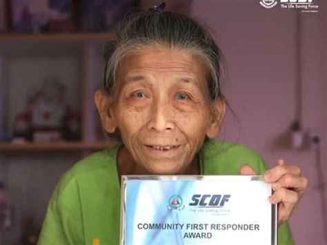 81 year old woman receives scdf award for helping put out fire at neighbour s flat today