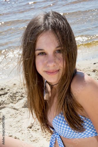 Teenager Girl In Blue Swimming Suit On The Beach Stock Photo And