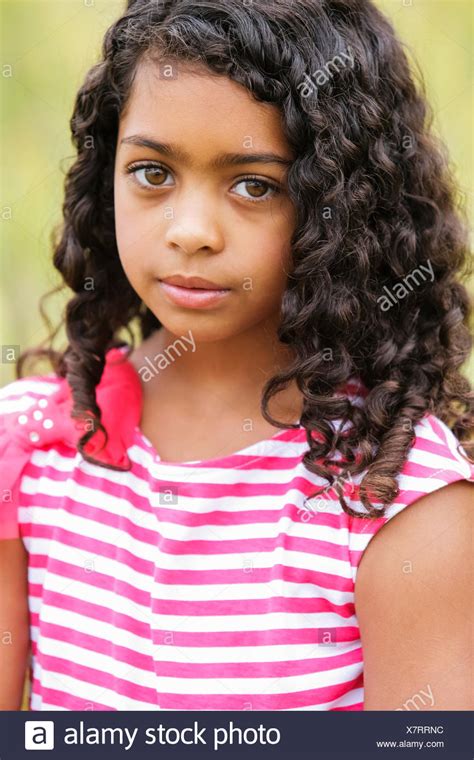Portrait Of A Young Girl With Dark Curly Hair And Big