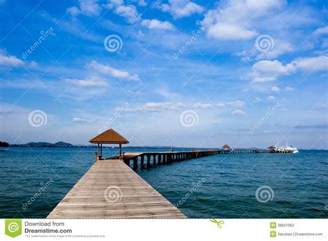 Wooden Jetty On Over The Beautiful Beach With Blue Stock