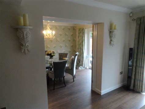 Enlarged grilles on the doors mimic the look of windows. Garage conversion into a formal dining room with internal ...