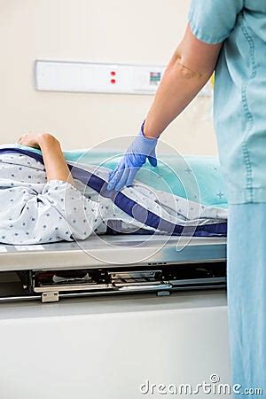 Nurse Standing By Patient Lying On Xray Table Royalty Free Stock Photo