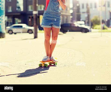 Teenage Girl Riding Skateboard On City Street Stock Photo Alamy