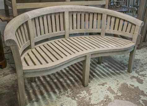Banana Garden Bench Weathered Teak Of Slatted Construction Of Curved Form And Rounded Back