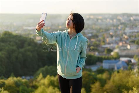 Portrait Of Sensual Japanese Woman With Short Hair Taking Selfie