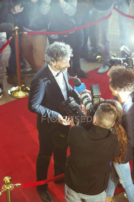 Celebrity Being Interviewed And Photographed By Paparazzi Photographers